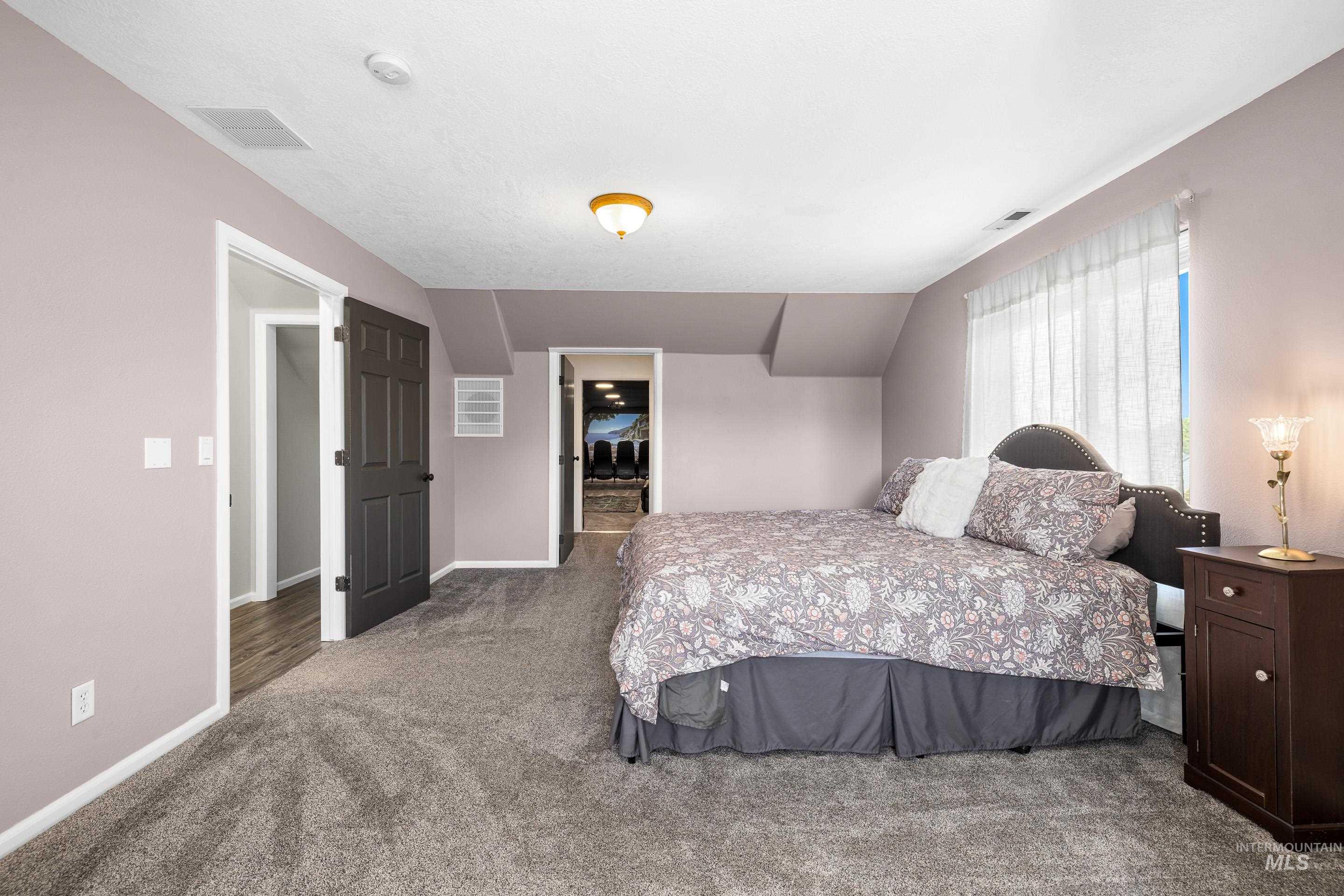 14119 Silver Ridge Road Caldwell, ID 83607 - Photo 34 of 50 Carpeted bedroom featuring baseboards