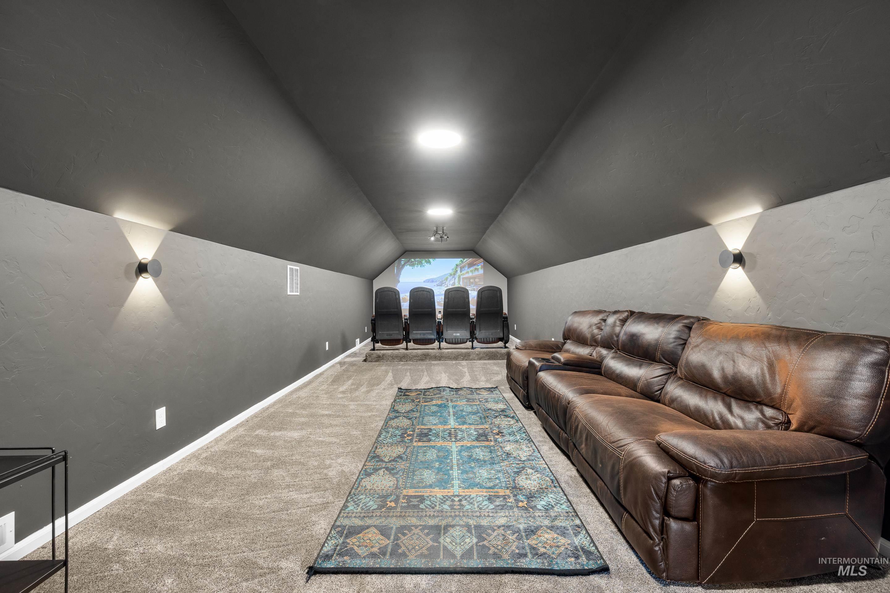 14119 Silver Ridge Road Caldwell, ID 83607 - Photo 35 of 50 Carpeted home theater with lofted ceiling and baseboards