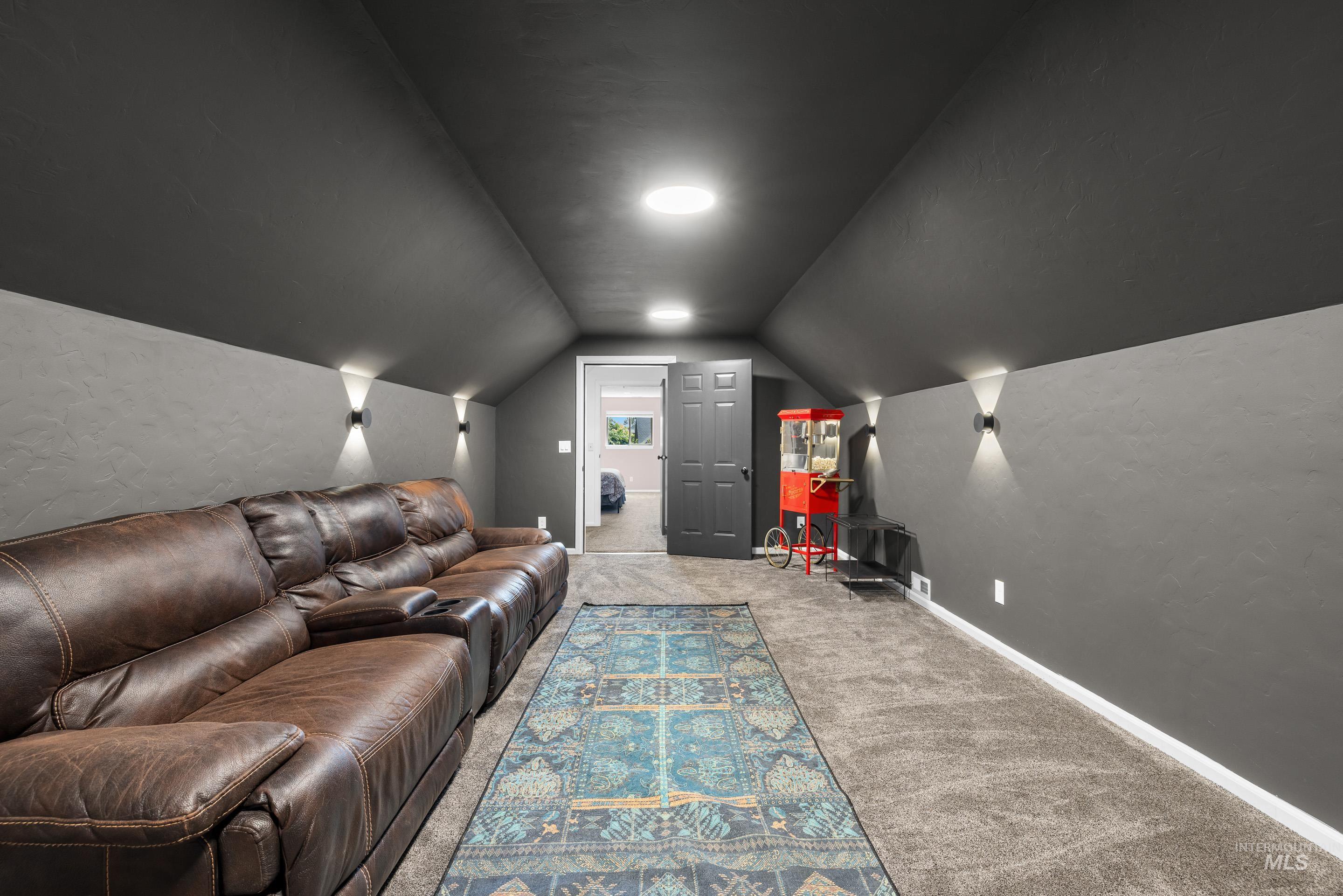 14119 Silver Ridge Road Caldwell, ID 83607 - Photo 37 of 50 Cinema with lofted ceiling and carpet flooring