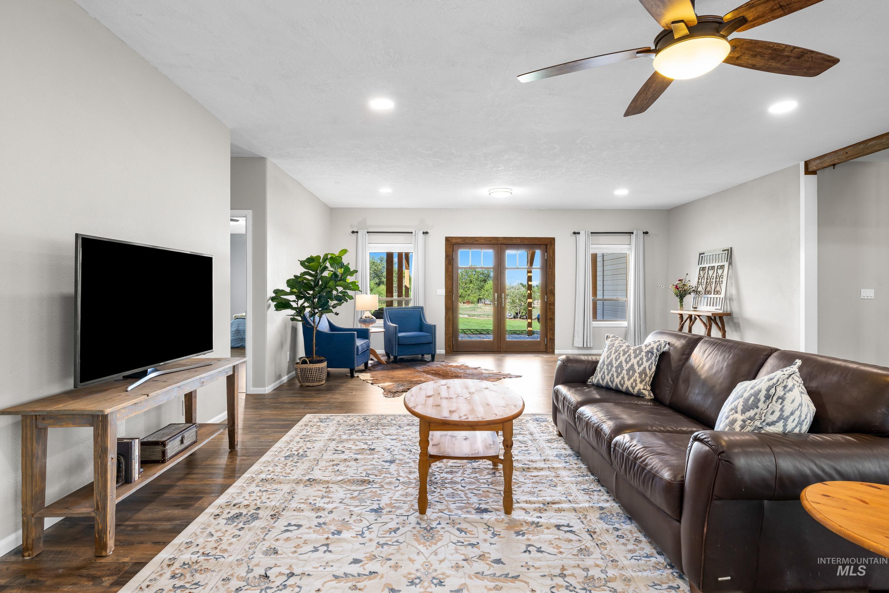 14119 Silver Ridge Road Caldwell, ID 83607 - Photo 7 of 50 Living area with dark wood-style flooring, a ceiling fan, french doors, and recessed lighting
