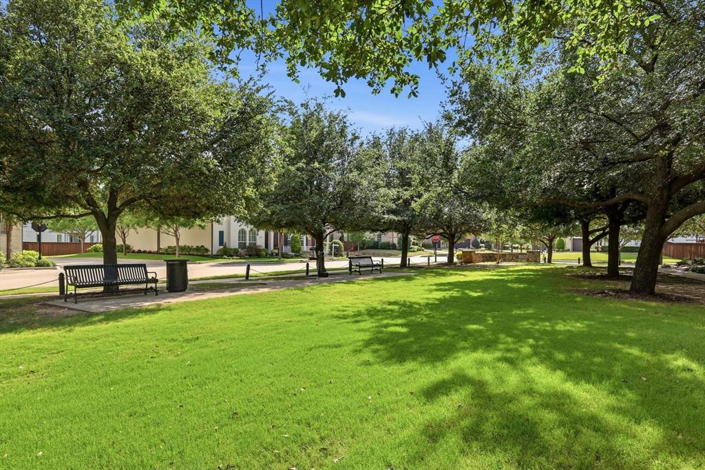 516 Sandy Lane Flower Mound, TX 75022 - Photo 4 of 38 Expansive green space featuring mature trees providing ample shade, paved walking paths, and multiple park benches