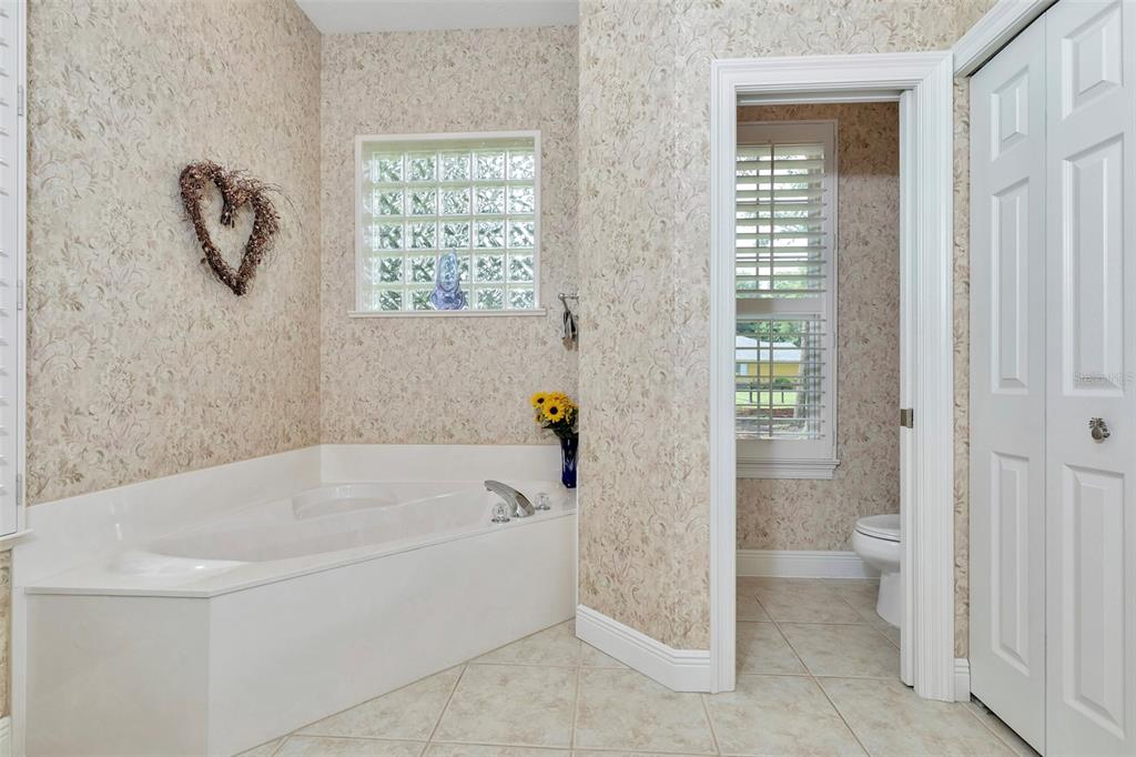 1989 Northwest 111th Loop Ocala, FL 34475 - Photo 26 of 55 a white bath tub sitting next to a toilet