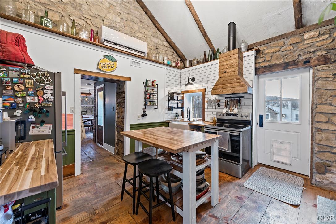 90 Crow Hill Road Barto, PA 19504 - Photo 15 of 41 a view of a kitchen with stainless steel appliances kitchen island granite countertop a table and chairs in it