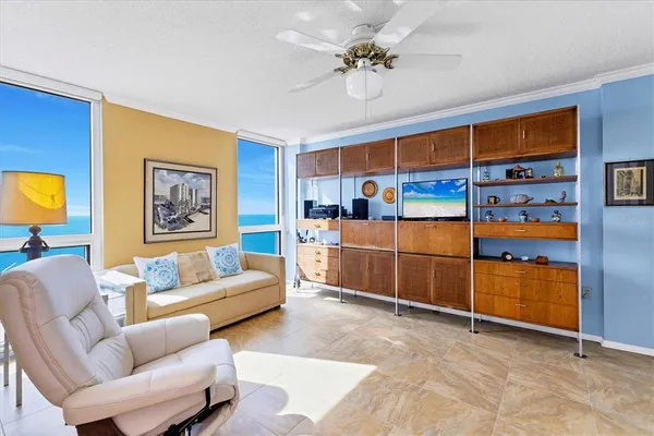 a living room with furniture and a chandelier