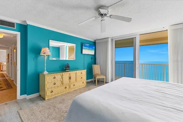 a bed sitting in a bedroom and chair