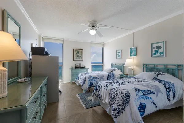 a bedroom with a bed dresser and wooden floor