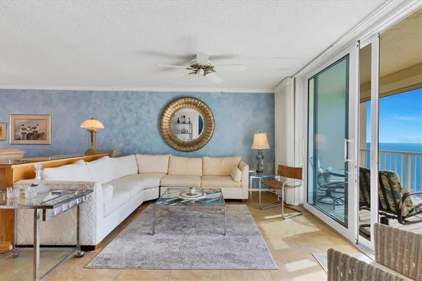 a living room with furniture and a mirror