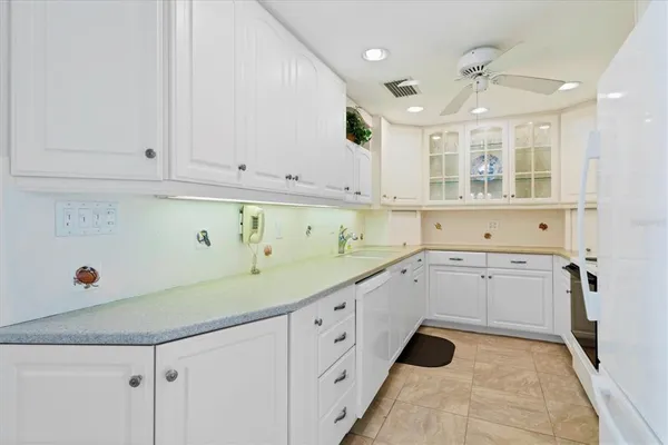 a kitchen with a sink cabinets and window