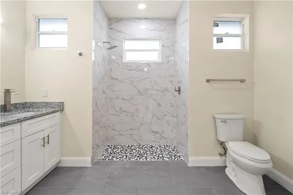 a white toilet sitting next to a white sink