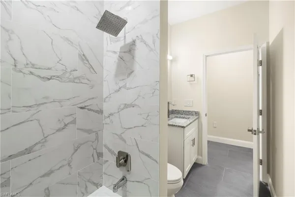 a view of a small space with wooden floor and a window