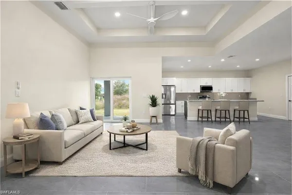 a living room with furniture and view of kitchen