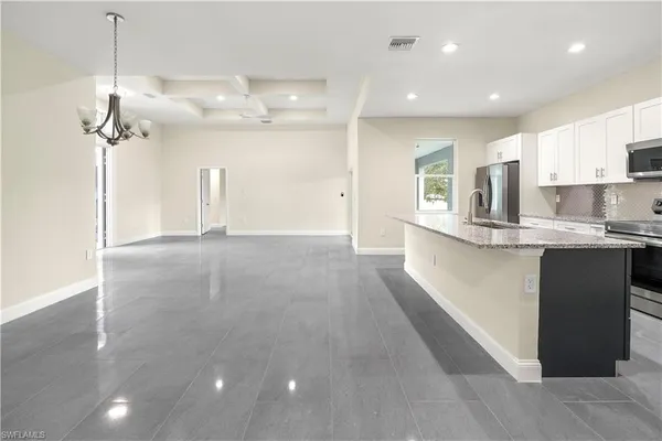 a view of a kitchen with a sink and microwave