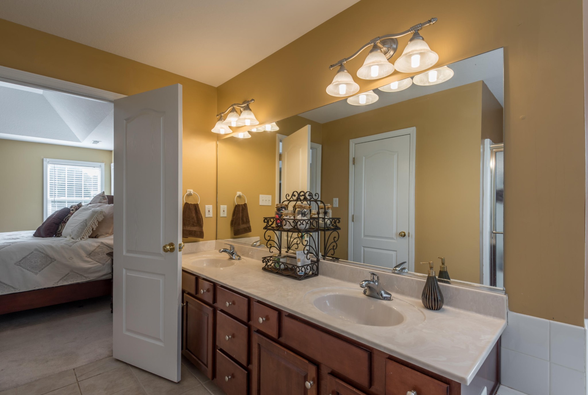 12665 Clear Ridge Road Knoxville, TN 37922 - Photo 28 of 39 a en suite bathroom with a double vanity sink and a mirror
