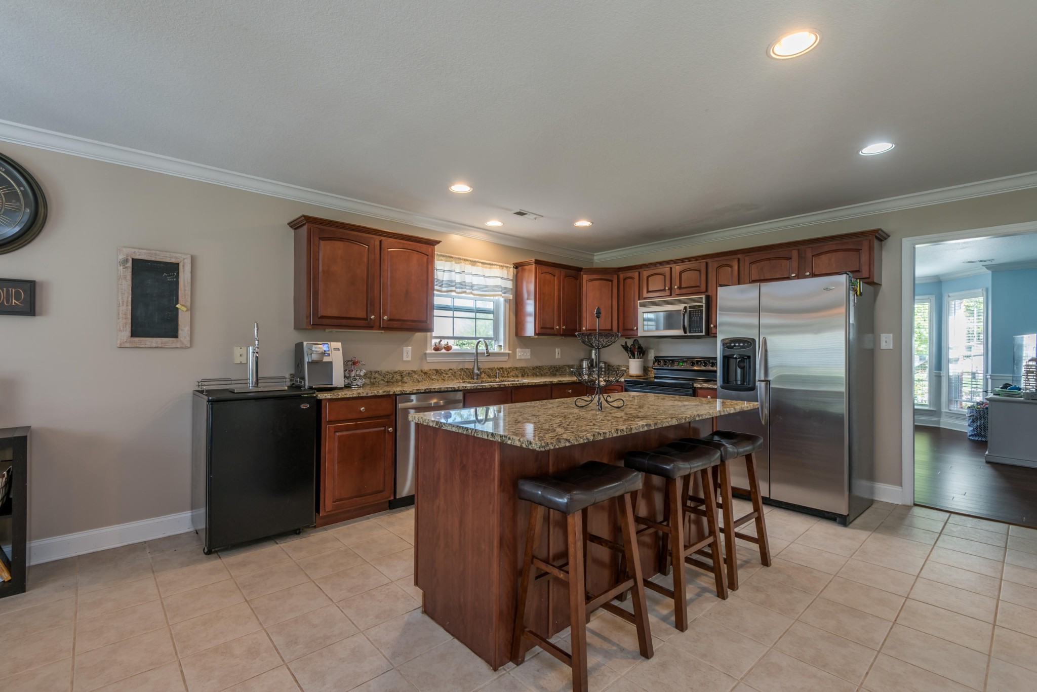 12665 Clear Ridge Road Knoxville, TN 37922 - Photo 6 of 39 a kitchen with stainless steel appliances granite countertop a stove a refrigerator a sink a microwave and island