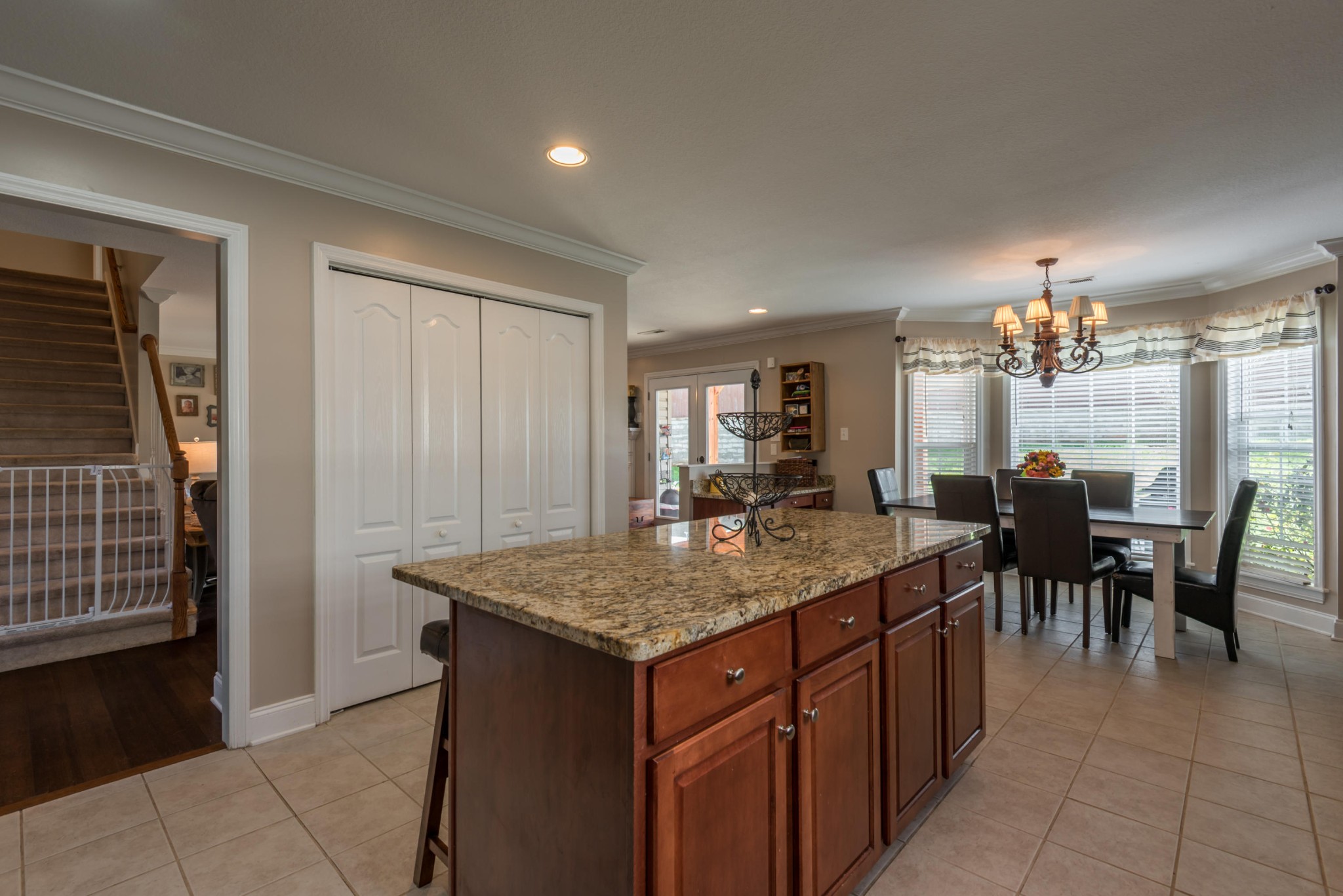 12665 Clear Ridge Road Knoxville, TN 37922 - Photo 8 of 39 a dining hall with stainless steel appliances granite countertop a dining table and chairs with wooden floor