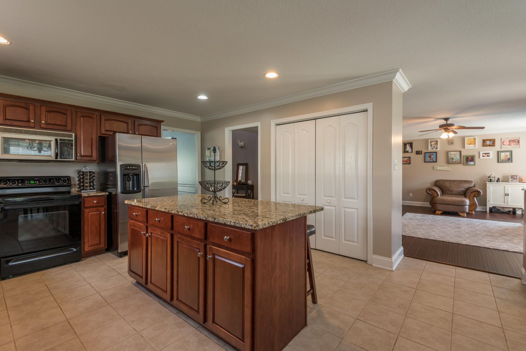 12665 Clear Ridge Road Knoxville, TN 37922 - Photo 9 of 39 a kitchen with kitchen island granite countertop a stove oven and a refrigerator with cabinets