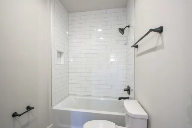 a bathroom with a bathtub and shower