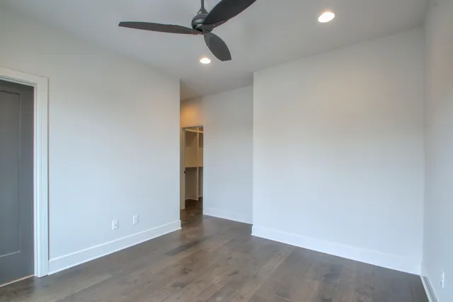 an empty room with a empty space and a ceiling fan