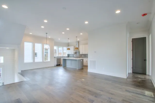 a view of kitchen with kitchen island and stainless steel appliances