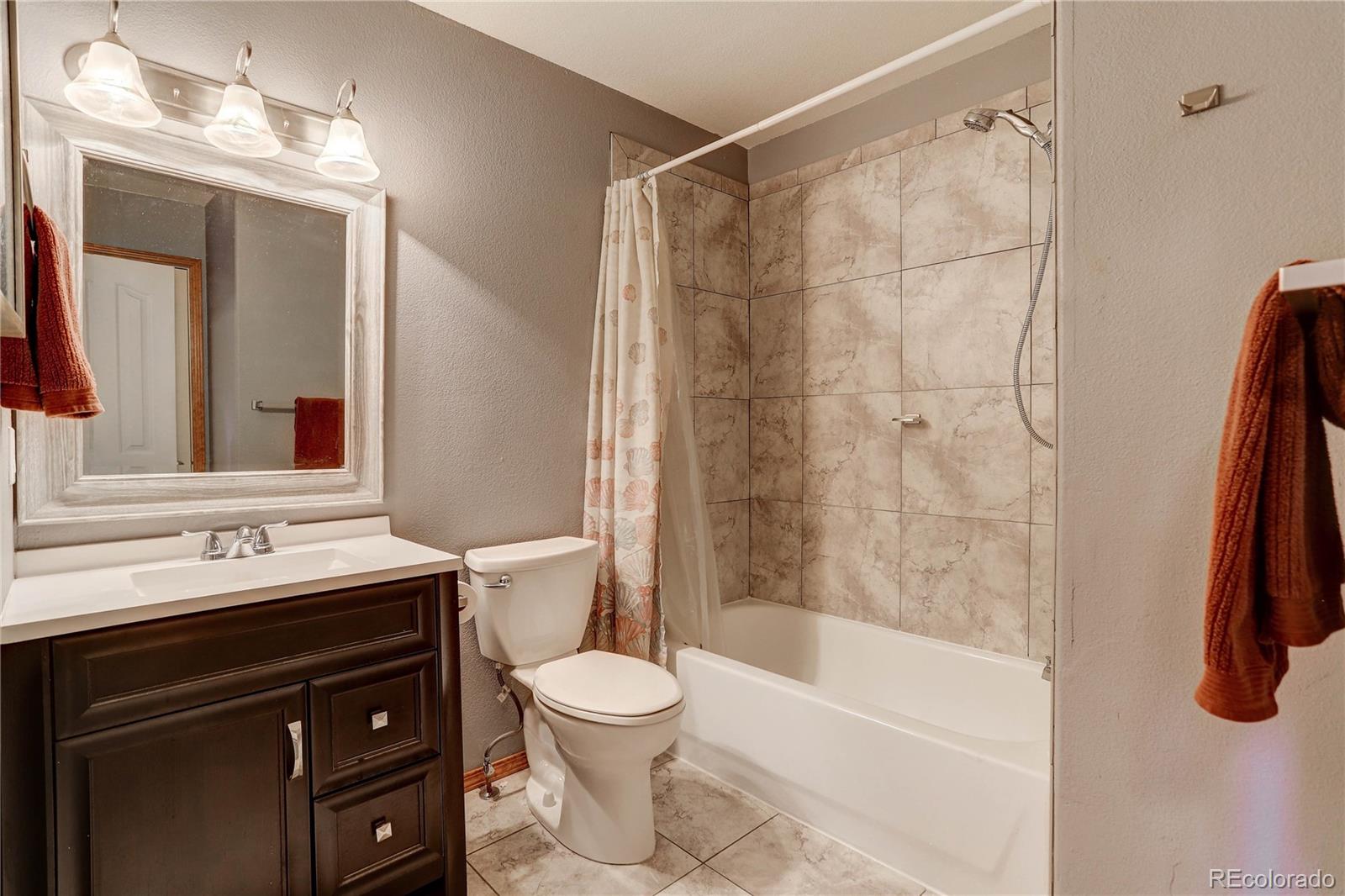 10922 Conifer Mountain Road Conifer, CO 80433 - Photo 18 of 37 a bathroom with a sink and a mirror