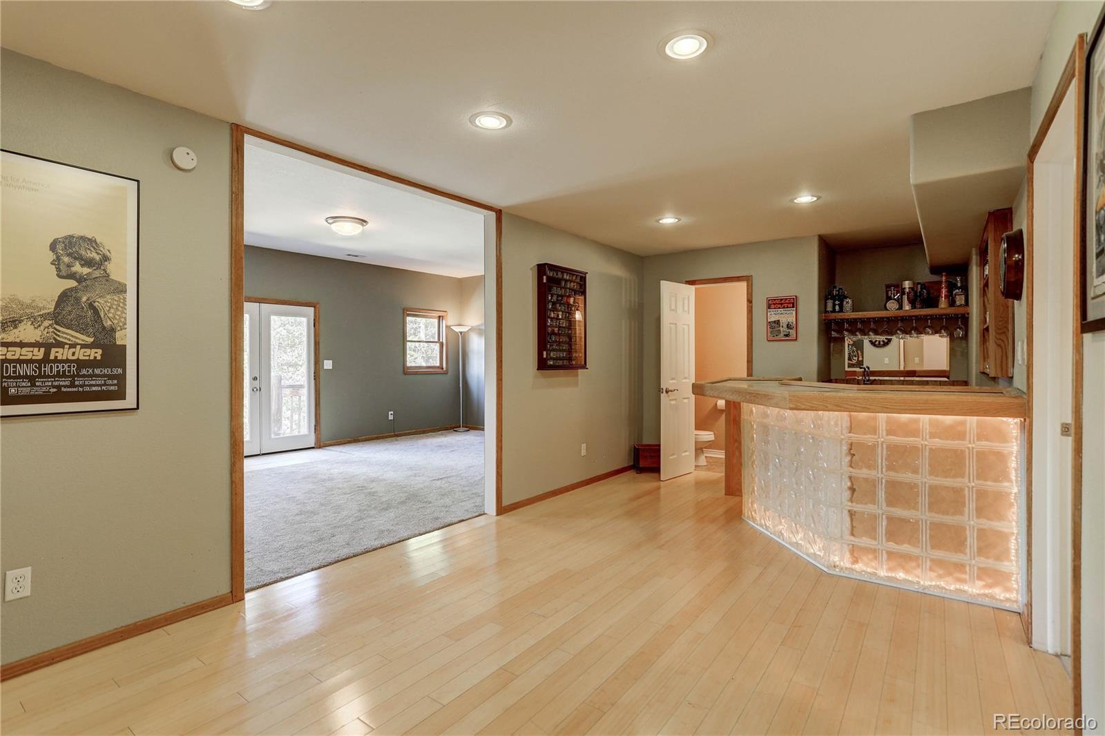 10922 Conifer Mountain Road Conifer, CO 80433 - Photo 27 of 37 a view of a kitchen with furniture and wooden floor