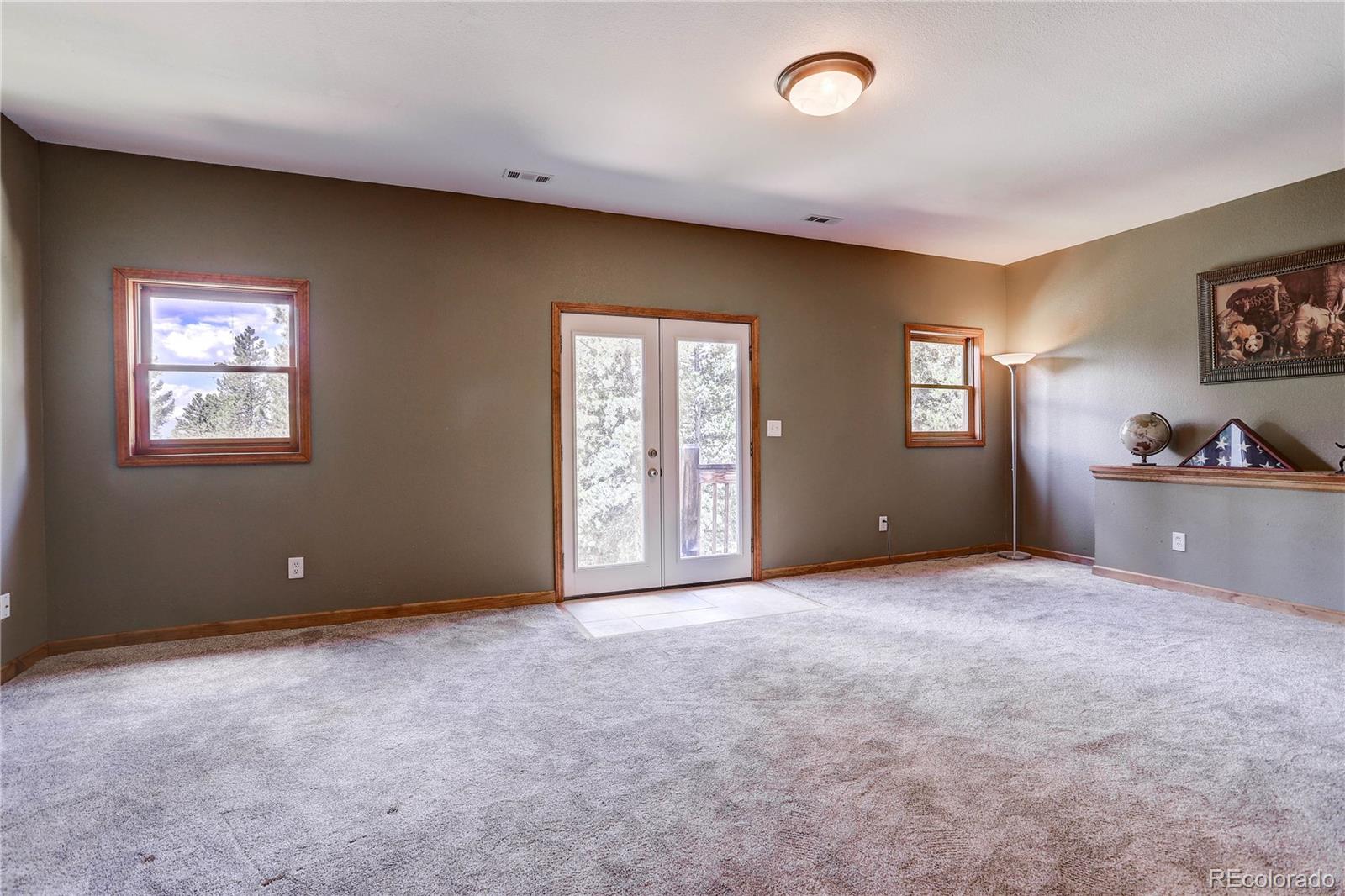 10922 Conifer Mountain Road Conifer, CO 80433 - Photo 29 of 37 a view of an empty room with a window