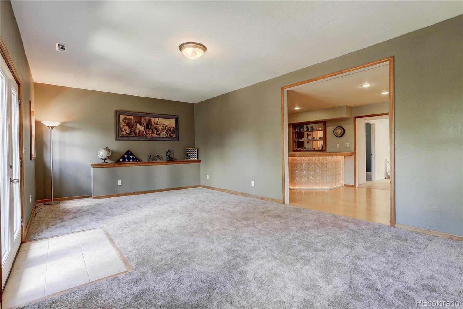 10922 Conifer Mountain Road Conifer, CO 80433 - Photo 30 of 37 a view of a big room with wooden floor and cabinet