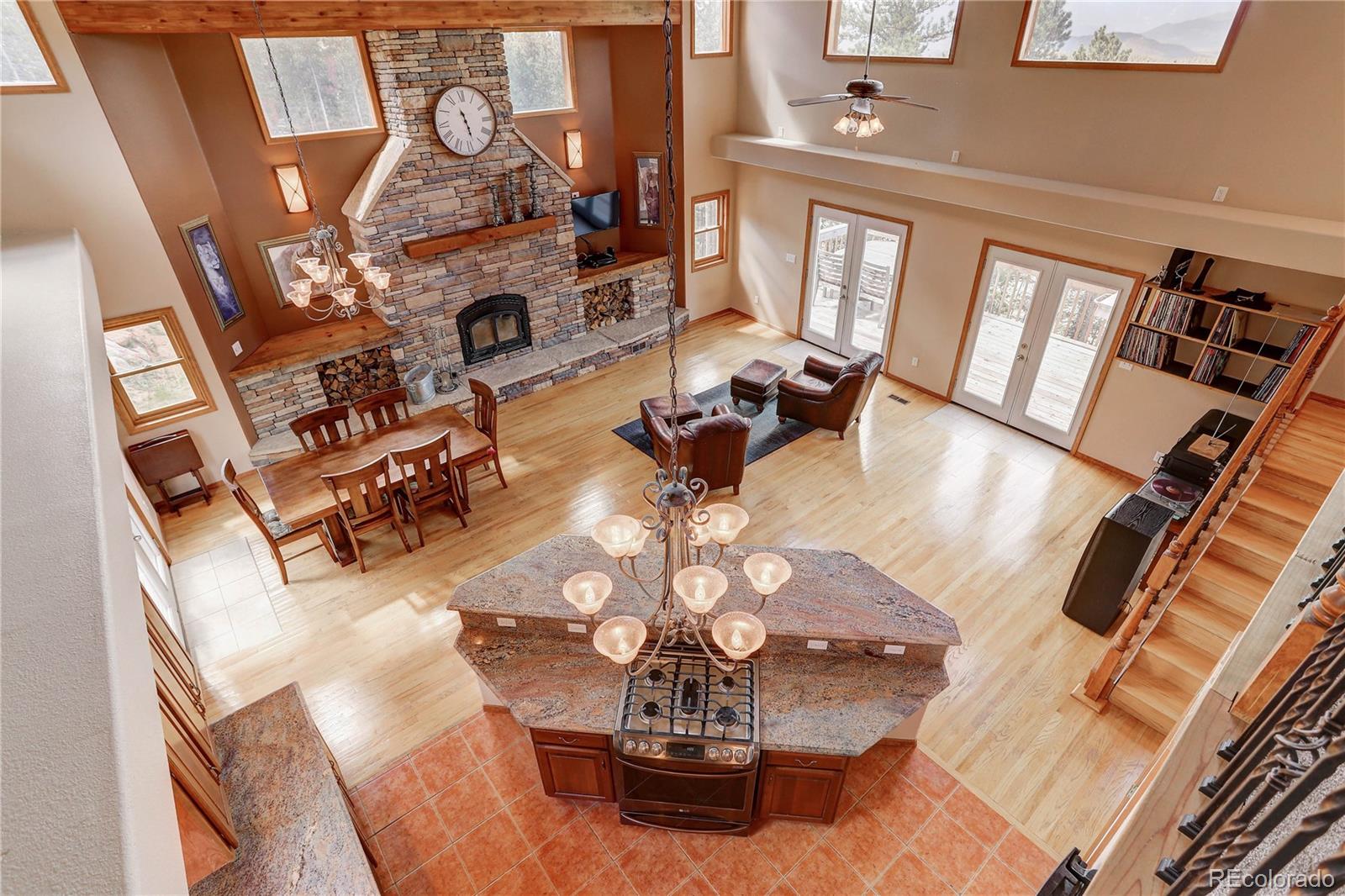 10922 Conifer Mountain Road Conifer, CO 80433 - Photo 3 of 37 a view of living room with furniture and a fireplace