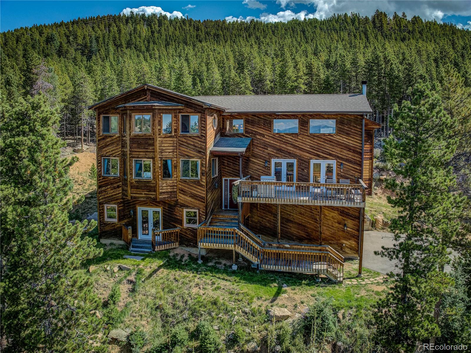 10922 Conifer Mountain Road Conifer, CO 80433 - Photo 33 of 37 a backyard of a house with a garden