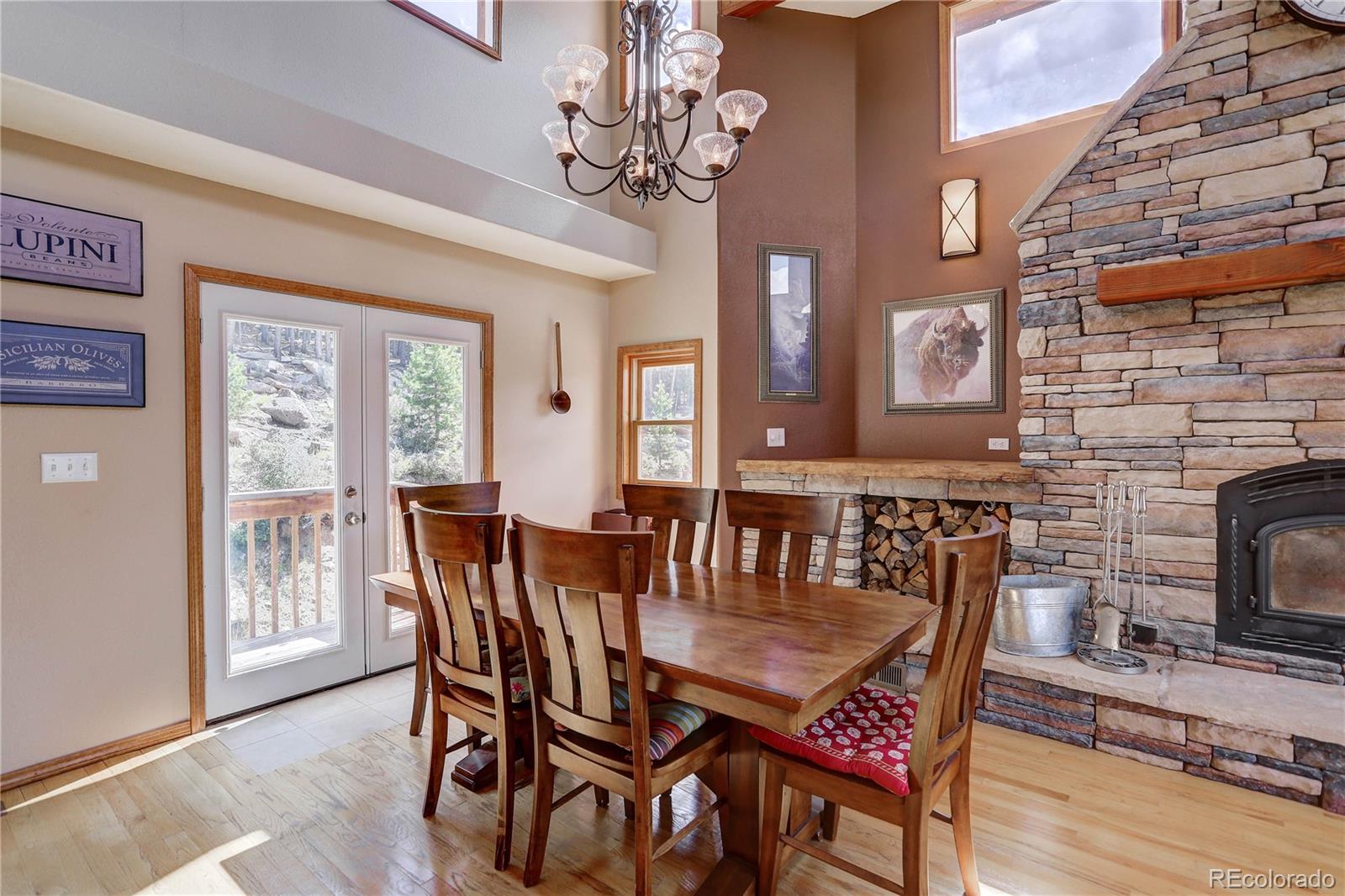 10922 Conifer Mountain Road Conifer, CO 80433 - Photo 6 of 37 a view of a dining room with furniture window and wooden floor