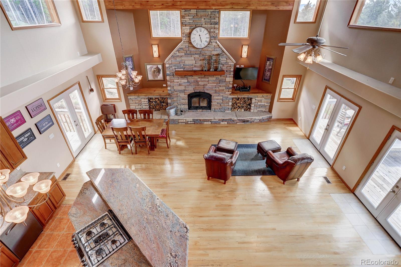 10922 Conifer Mountain Road Conifer, CO 80433 - Photo 9 of 37 a living room with furniture and a fireplace