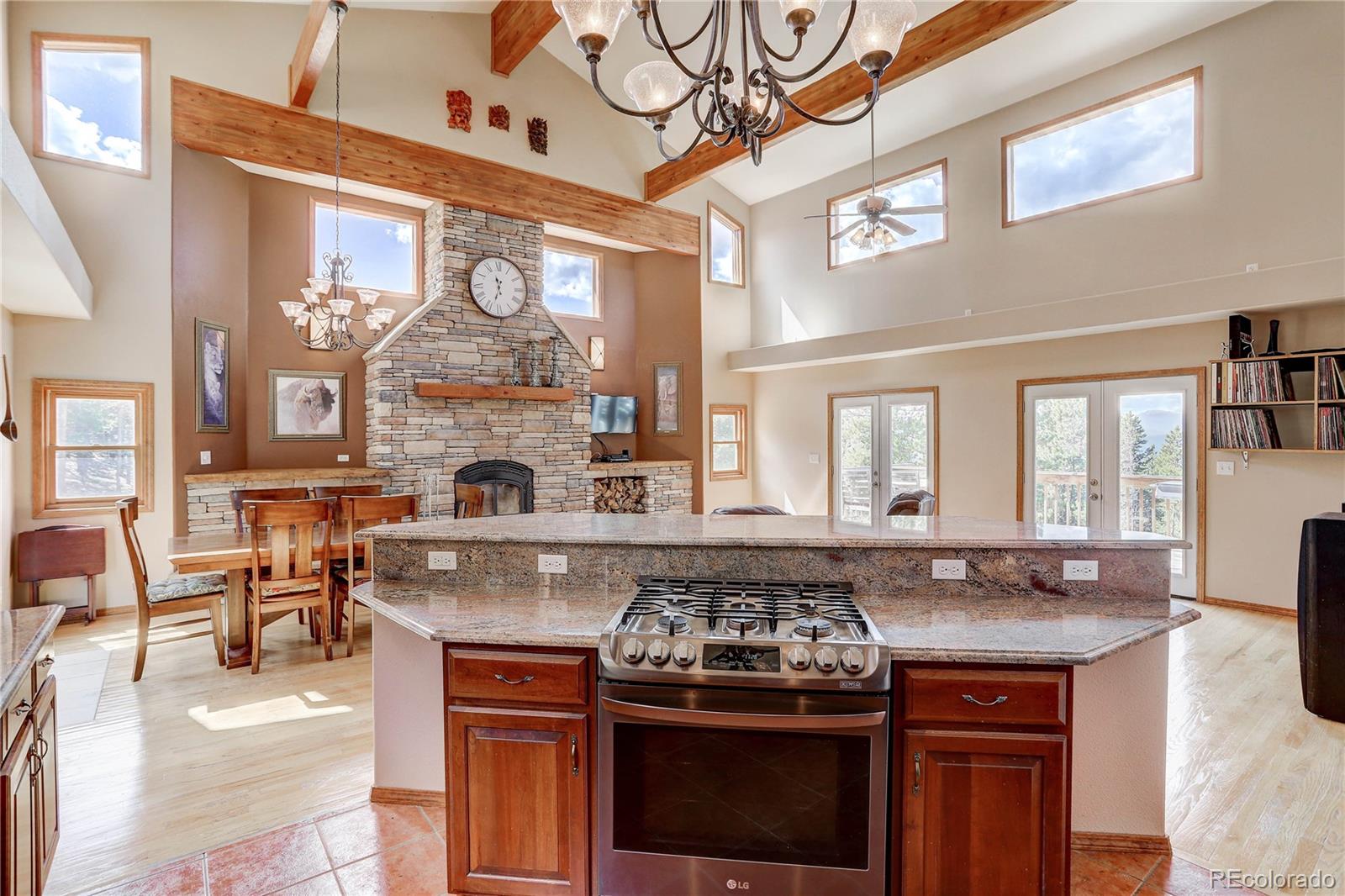 10922 Conifer Mountain Road Conifer, CO 80433 - Photo 10 of 37 a view of a kitchen with stainless steel appliances granite countertop a stove and a fireplace