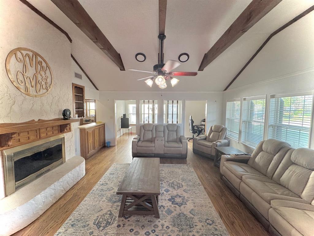 a living room with furniture a fireplace and a chandelier