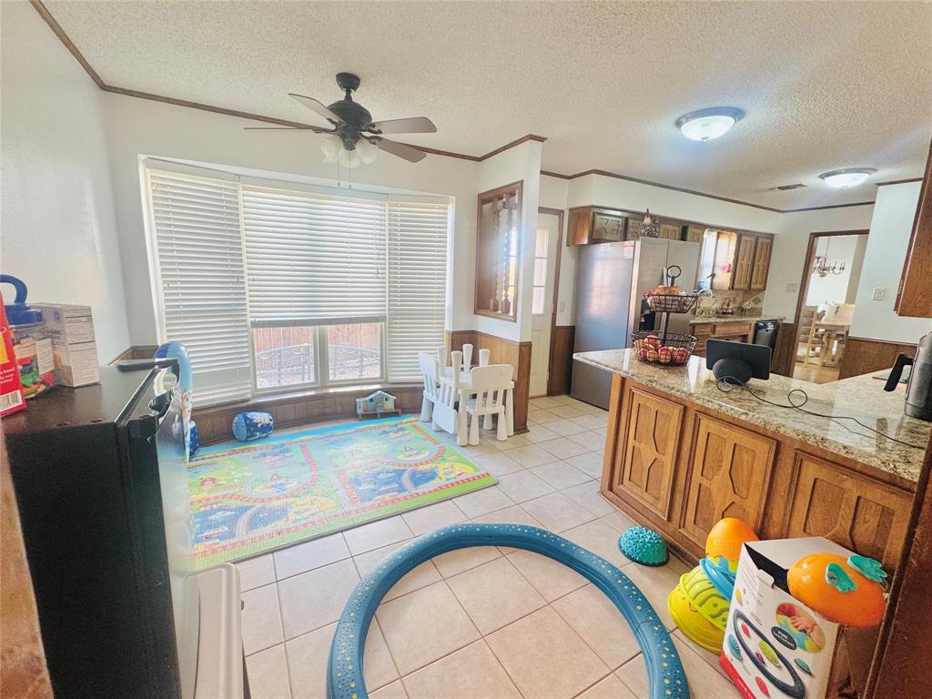 1109 Simpson Terrace Bedford, TX 76021 - Photo 14 of 39 a living room with kitchen island furniture and a table