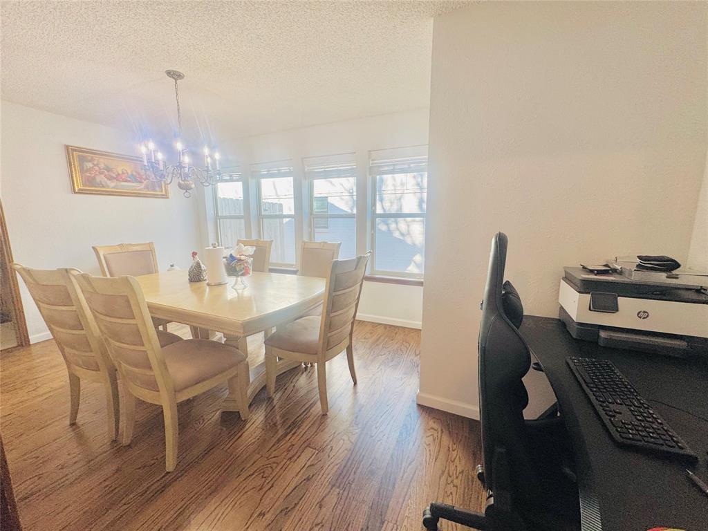 1109 Simpson Terrace Bedford, TX 76021 - Photo 18 of 39 a view of a dining room with furniture and wooden floor