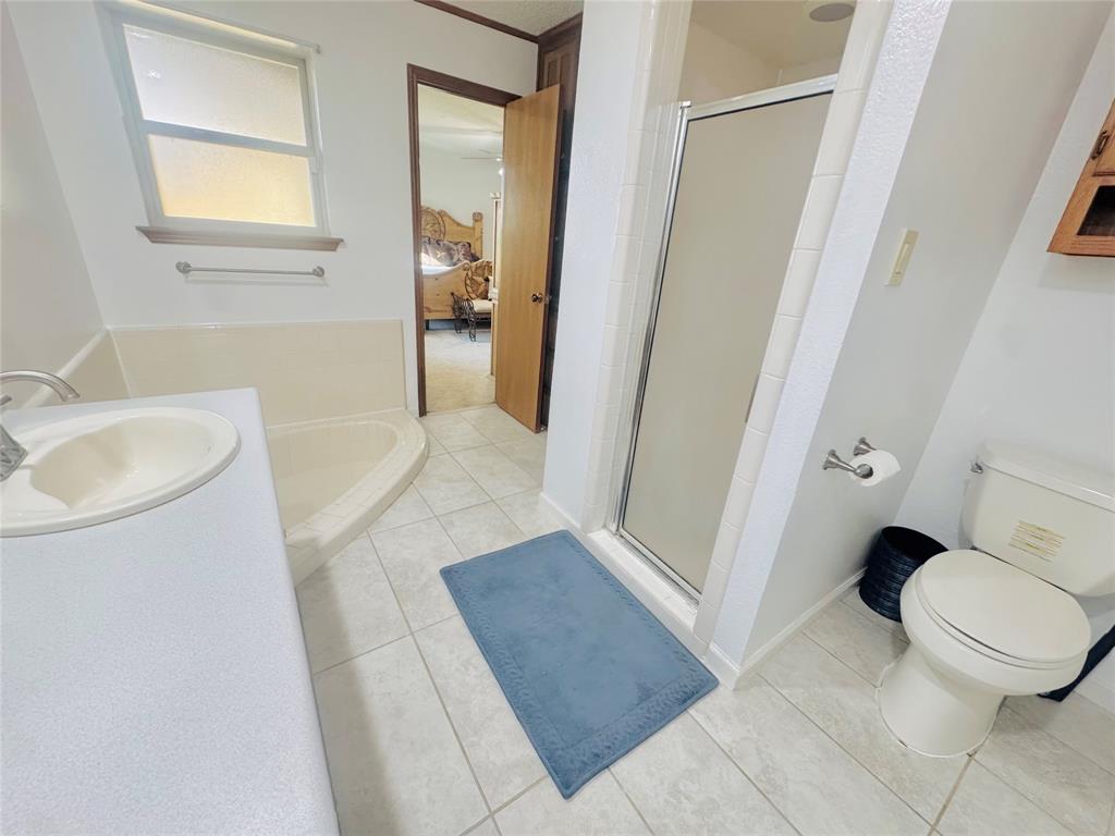1109 Simpson Terrace Bedford, TX 76021 - Photo 28 of 39 a bathroom with a sink a toilet and a shower
