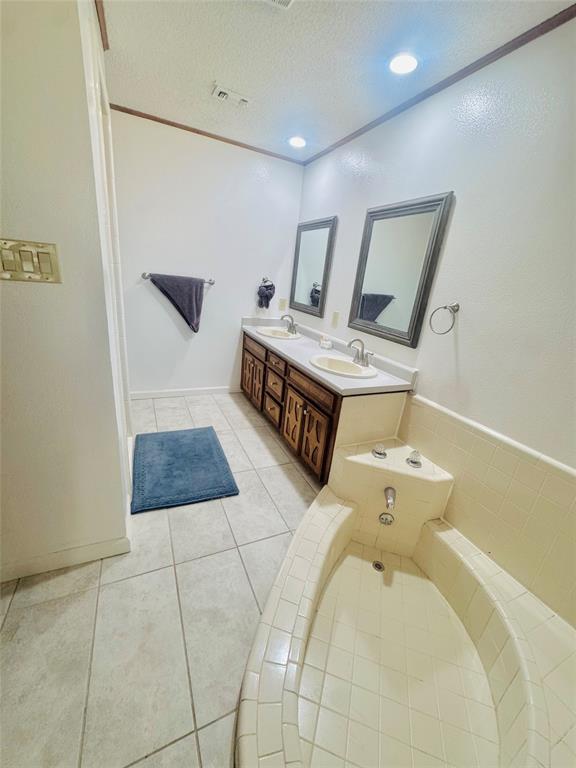 1109 Simpson Terrace Bedford, TX 76021 - Photo 30 of 39 a spacious bathroom with a toilet sink and mirror