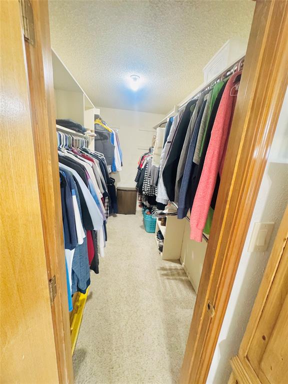 1109 Simpson Terrace Bedford, TX 76021 - Photo 33 of 39 a view of walk in closet with clothes and shoes