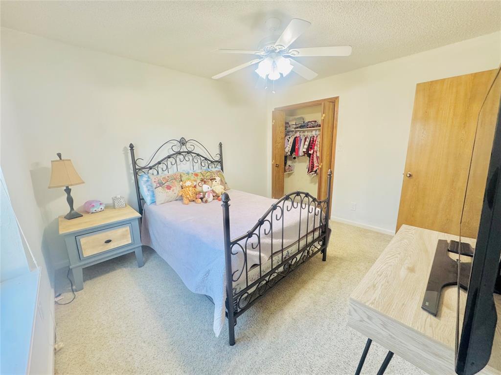 1109 Simpson Terrace Bedford, TX 76021 - Photo 6 of 39 a bedroom with a bed and a chandelier