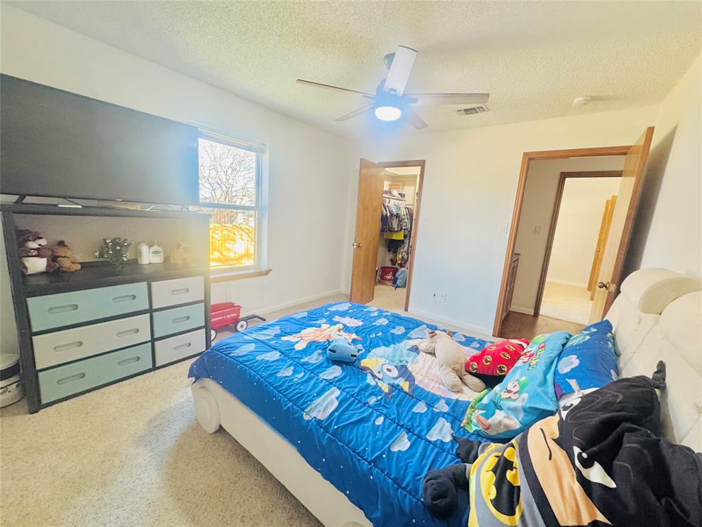 1109 Simpson Terrace Bedford, TX 76021 - Photo 7 of 39 a bedroom with a bed and a dresser in it