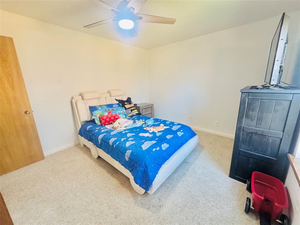 1109 Simpson Terrace Bedford, TX 76021 - Photo 8 of 39 a bedroom with a bed and wooden floor