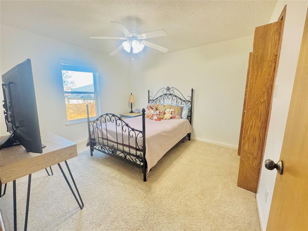 1109 Simpson Terrace Bedford, TX 76021 - Photo 9 of 39 a bed room with a bed and a window