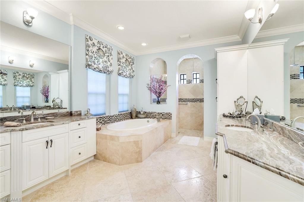 7304 Hagen Way Naples, FL 34113 - Photo 13 of 37 Bathroom with a bath, crown molding, a walk in shower, and a sink