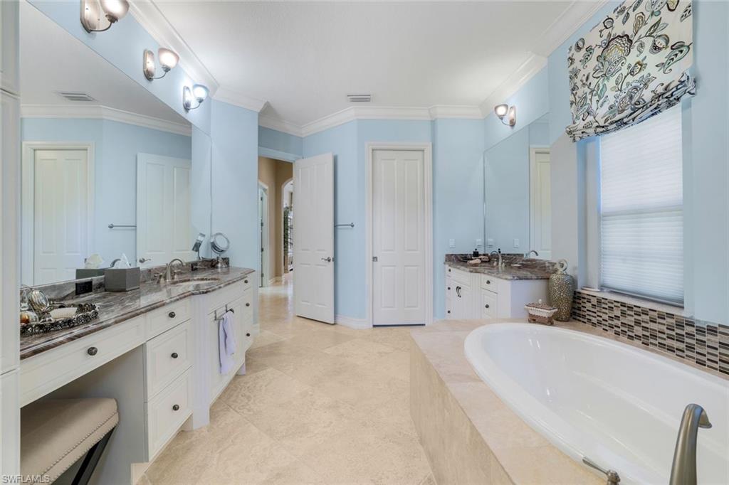 7304 Hagen Way Naples, FL 34113 - Photo 15 of 37 Bathroom with a bath, ornamental molding, a sink, and two vanities