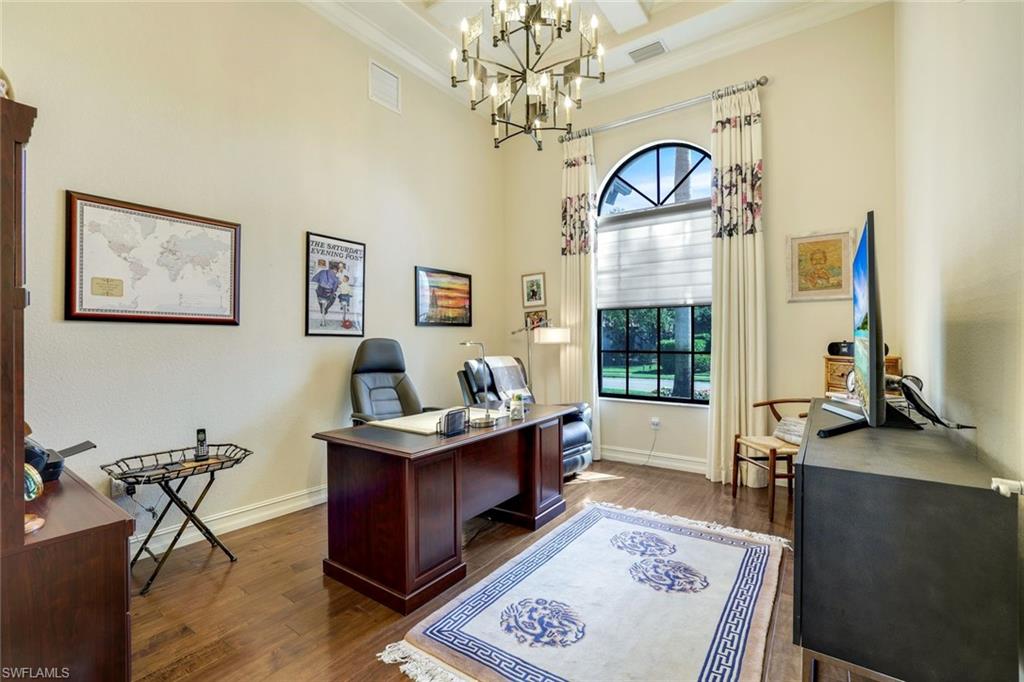 7304 Hagen Way Naples, FL 34113 - Photo 16 of 37 Office space with dark wood-style floors, a notable chandelier, visible vents, and ornamental molding