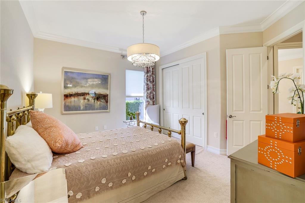 7304 Hagen Way Naples, FL 34113 - Photo 19 of 37 Bedroom with baseboards, a closet, crown molding, and carpet floors