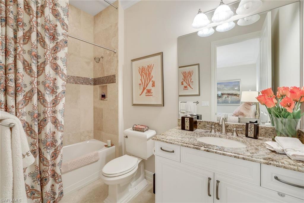 7304 Hagen Way Naples, FL 34113 - Photo 20 of 37 Bathroom featuring tile patterned floors, toilet, vanity, shower / bathtub combination with curtain, and a chandelier