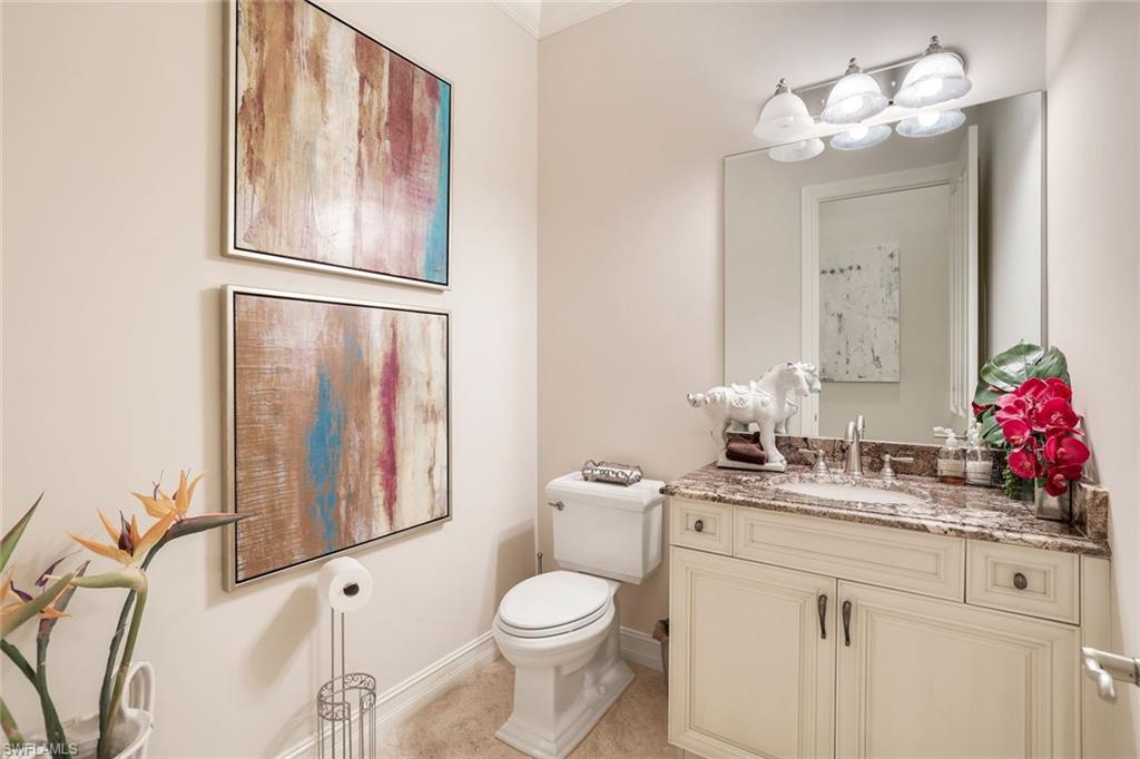 7304 Hagen Way Naples, FL 34113 - Photo 23 of 37 Half bathroom with baseboards, toilet, tile patterned flooring, and vanity