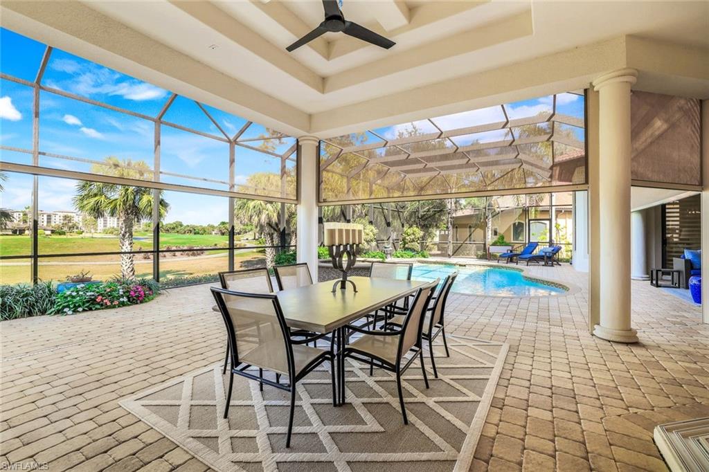 7304 Hagen Way Naples, FL 34113 - Photo 25 of 37 View of patio with glass enclosure, ceiling fan, outdoor dining area, and an outdoor pool