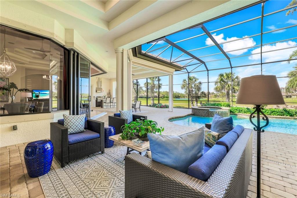 7304 Hagen Way Naples, FL 34113 - Photo 28 of 37 View of patio / terrace with outdoor lounge area, a pool with connected hot tub, and a lanai